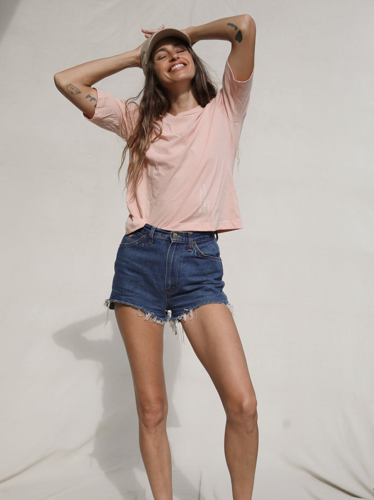The Mindry pink short sleeve T-shirt, worn by model front side facing camera.