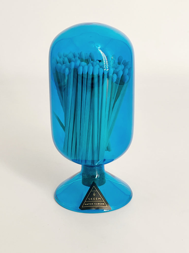 Indigo Match Cloche, made of stunning blown glass and holding an assortment of matchsticks.