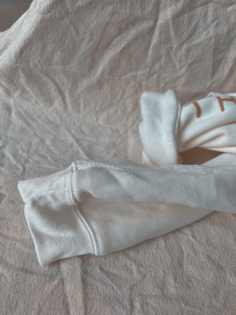 The Mindry cropped folded sweatshirt sleeves in white.